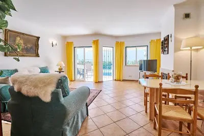 a living room with a couch and a table at Casa Felix mit Pool in Albufeira