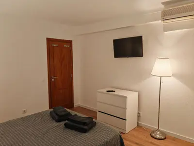 a bedroom with a bed and a lamp and a dresser at Apartamento Oura com piscina e vista mar in Albufeira
