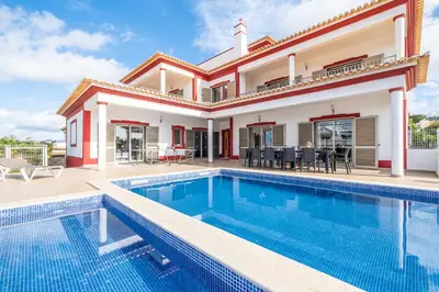 a villa with a swimming pool and a house at Villa Aica - BY BEDZY in Guia