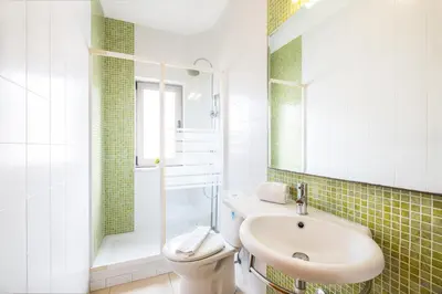a white bathroom with a sink and a toilet at Villa Aica - BY BEDZY in Guia
