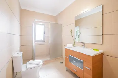 a bathroom with a toilet sink and a mirror at Villa Aica - BY BEDZY in Guia