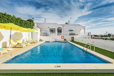 a villa with a swimming pool and a house at Casa Miranda in Albufeira