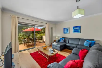 a living room with a couch and a table at Oleander Terrace Albufeira in Faro