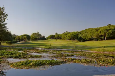 a view of a golf course with a pond at Oleander Terrace Albufeira in Faro