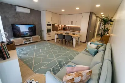 a large living room with a couch and a kitchen at be Unforgettable Apartment in Faro