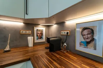 a room with two portraits of a man on the wall at be Unforgettable Apartment in Faro
