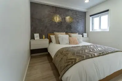 a bedroom with a large bed and a window at be Unforgettable Apartment in Faro