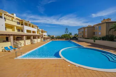 a swimming pool in the middle of a building at Sunny Haven Apartment Vilamoura in Vilamoura