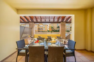 a dining room with a table and chairs at Sunny Haven Apartment Vilamoura in Vilamoura