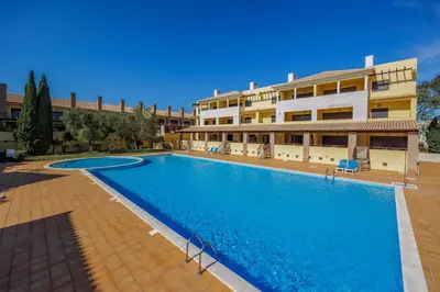 a large swimming pool in front of a building at Sunny Haven Apartment Vilamoura in Vilamoura