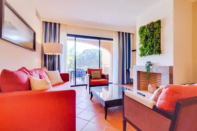 a living room with red furniture and a fireplace at AL - Apartamento Vila Sol N in Vilamoura