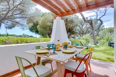 a white table and chairs on a patio at AL - Vila Barreira, near the golf in Vilamoura