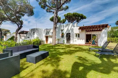 a garden with a couch and a house at AL - Vila Barreira, near the golf in Vilamoura