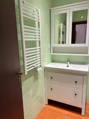 a bathroom with a sink and a mirror at Ouramar Apartment in Albufeira