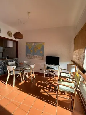 a living room with a table and chairs at Ouramar Apartment in Albufeira