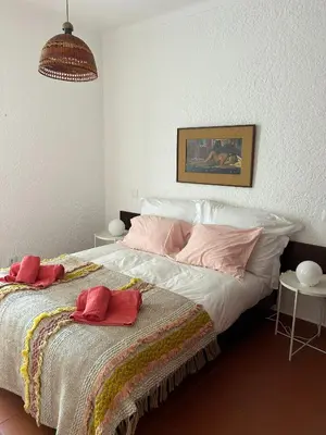 a bedroom with a bed with two towels on it at Ouramar Apartment in Albufeira