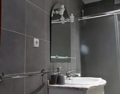 a bathroom with a sink and a mirror at Apartamento Brisa Mar in Albufeira