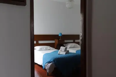 a mirror reflection of a bedroom with two beds at Apartamento Brisa Mar in Albufeira