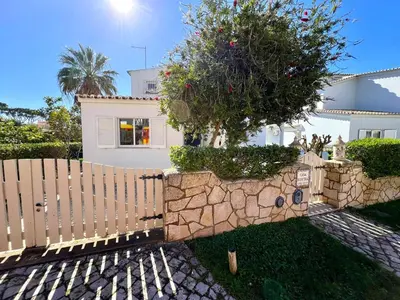 a white house with a fence and a tree at Vilamoura Brightness Villa With Pool by Homing in Vilamoura