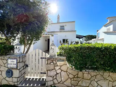 a white house with a gate and a fence at Vilamoura Brightness Villa With Pool by Homing in Vilamoura