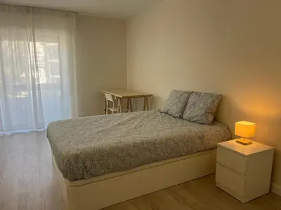 a bedroom with a bed and a lamp on a night stand at Montinho - Apartamento in Faro