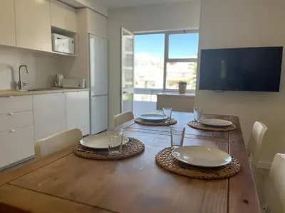 a dining room table with plates and glasses on it at Montinho - Apartamento in Faro