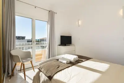 a bedroom with a bed and a chair and a window at Villa Verde by IntiHolidays in Guia