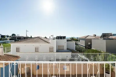 a white fence in front of a white house at Villa Verde by IntiHolidays in Guia