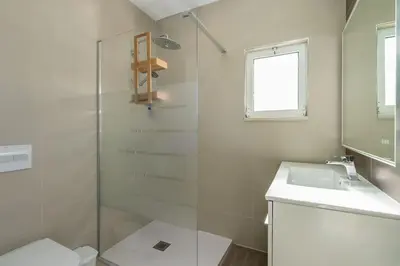 a bathroom with a glass shower and a sink at Villa Verde by IntiHolidays in Guia