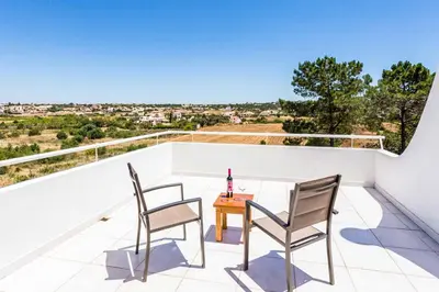 two chairs and a table on a balcony with a view at Villa Bonita Gale in Galé