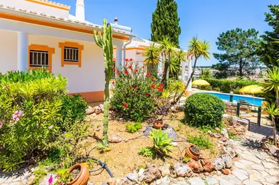 a garden in front of a house with a pool at Villa Bonita Gale in Galé