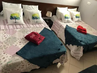 two beds with pillows on them in a bedroom at Villa Martin in Albufeira