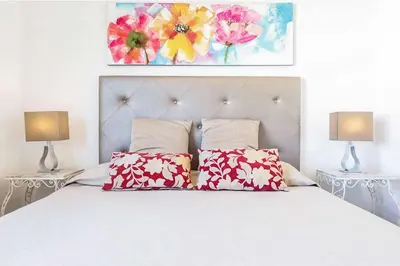 a bedroom with a white bed with two lamps at Casa do Engenho in Galé