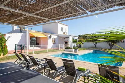 a patio with chairs and a swimming pool at Casa do Engenho in Galé