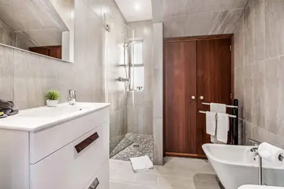 a bathroom with a sink and a tub and a toilet at Villa Timoneiro in Galé