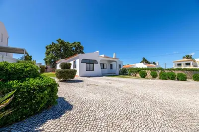 a driveway in front of a white house at Villa Rosa dos Ventos in Galé
