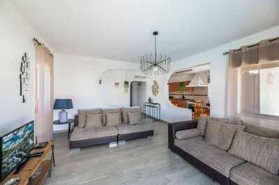 a living room with two couches and a tv at Villa Rosa dos Ventos in Galé