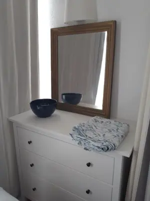a dresser with a mirror and two bowls on it at BEACH HOUSE in Olhos de Água