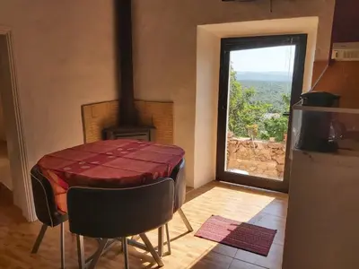 a table and chairs in a kitchen with a window at Bela Vista House - Quinta amoreira in Benafim