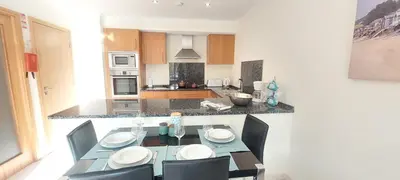 a kitchen with a table and chairs in a kitchen at Apartment Lucia Albufeira in Olhos de Água