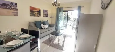 a living room with a couch and a table at Apartment Lucia Albufeira in Olhos de Água
