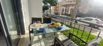 a table on a balcony with food on it at Apartment Lucia Albufeira in Olhos de Água