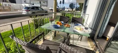 a balcony with a table with a plate of food on it at Apartment Lucia Albufeira in Olhos de Água