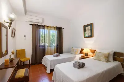 a hotel room with two beds and a window at Casa Mila by Sunnyway in Olhos de Água