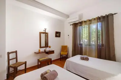 a bedroom with two beds and a mirror at Casa Mila by Sunnyway in Olhos de Água