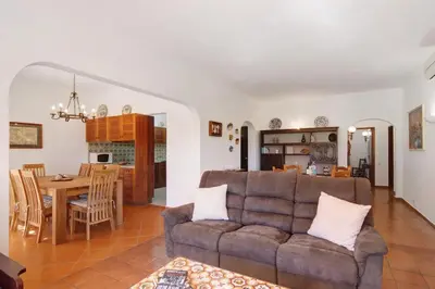 a living room with a couch and a table at Casa Mila by Sunnyway in Olhos de Água