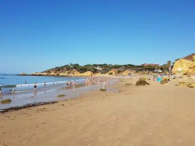 a group of people standing on a beach at Casa Mila by Sunnyway in Olhos de Água