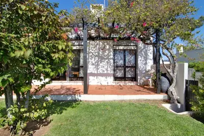 a house with a garden and some trees and grass at Casa Mila by Sunnyway in Olhos de Água