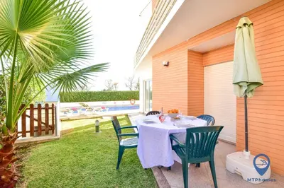 a front door of a house with stairs and plants at Vila Alfarrobeira by MTPhomes in Albufeira