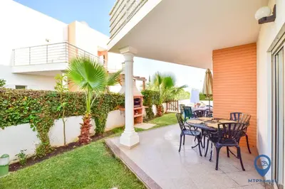 a patio with a table and chairs in a house at Vila Alfarrobeira by MTPhomes in Albufeira